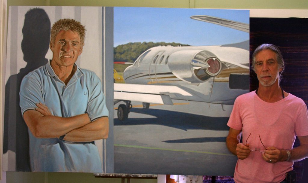 Part-time weed management officer Raymond Cheney with his portrait of Mick Doohan.